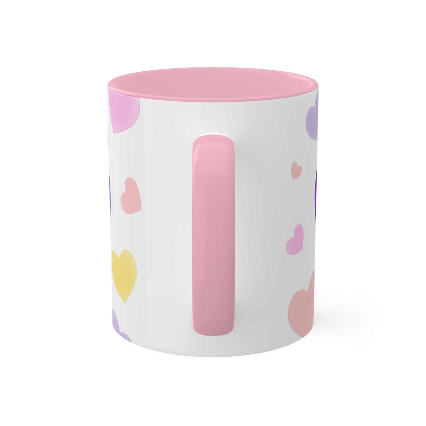 Colorful ceramic "Love Mug MODEL B-V-10" with heart designs and pink handle.