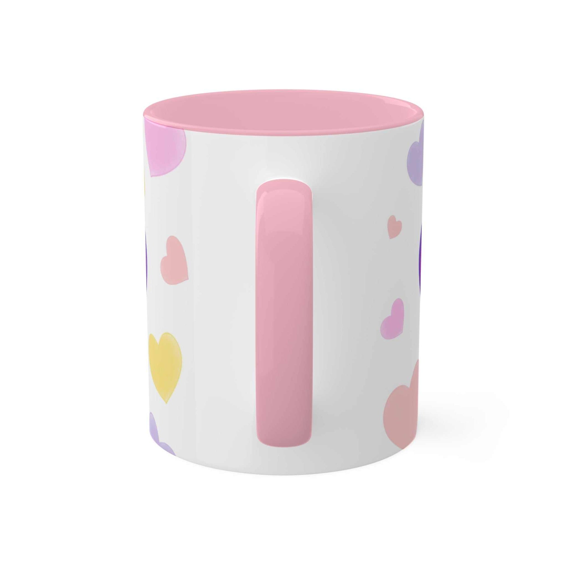 Colorful ceramic "Love Mug MODEL B-V-10" with heart designs and pink handle.